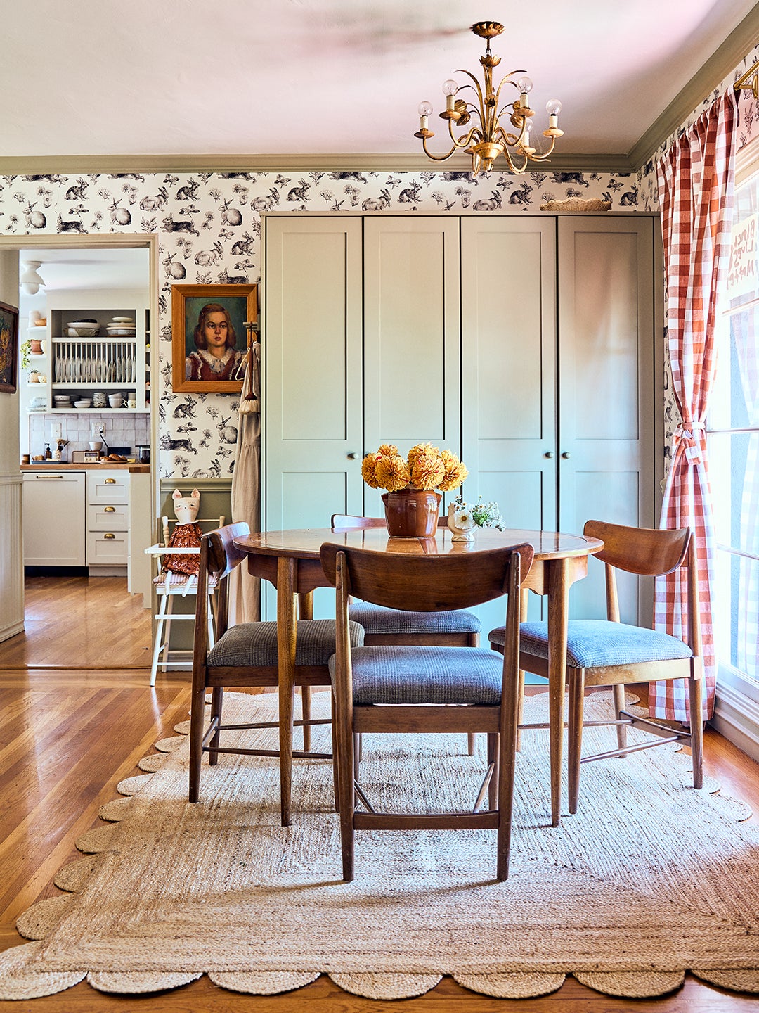 wallpapered dining room with built-in cabinets